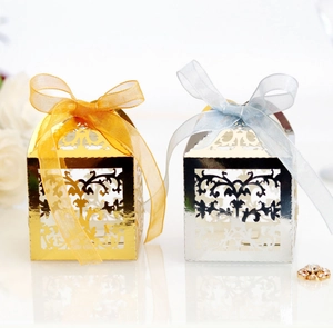 Detailed laser cut lace gift boxes in gold and silver with elegant organza ribbon bows