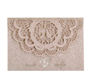 Glitter laser cut wedding invitation card with intricate lace details in champagne gold