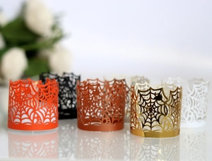 Detailed laser-cut spider web lace candle wraps in multiple metallic finish colors