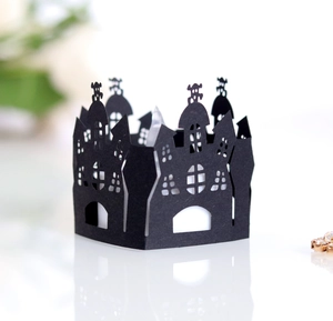 Halloween black laser-cut castle cupcake wrapper with skull pattern on white reflection