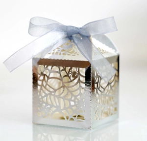 Detailed laser-cut silver spider web candy box with a lilac ribbon for Halloween parties