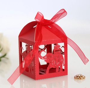 Détail boîte à bonbons rouge découpée au laser avec motif éléphant et ruban cadeau