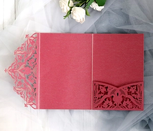 Macro shot of laser cut burgundy wedding invitation cover with lace hollow out pattern