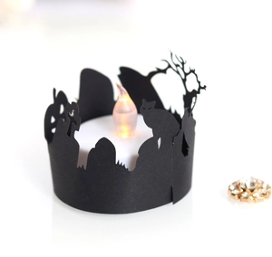 Detail of Halloween laser-cut paper lantern featuring a black cat, pumpkin, and LED candle
