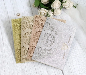 Lace laser-cut wedding invitation cards in gold and silver glitter finishes