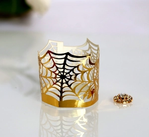Golden laser-cut spider web decorative wrap with metallic shine for Halloween tea lights