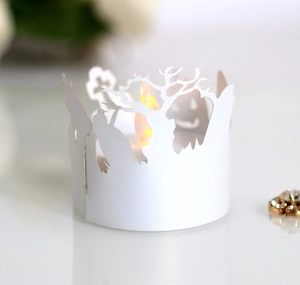 Close-up of laser-cut Halloween paper lantern with pumpkin and tree patterns and LED light