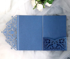 Close-up of laser cut navy blue wedding invitation cover with intricate lace detailing