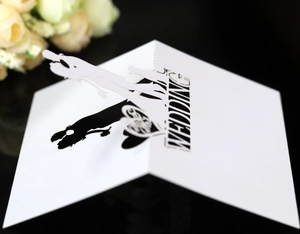 Elegant laser cut pop-up wedding card featuring bride and groom silhouette design
