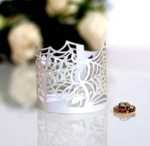 Macro shot of white laser-cut spider web paper wrap with elegant pearlescent finish