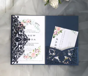 Detailed laser-cut navy blue wedding invitation set with floral card and RSVP note