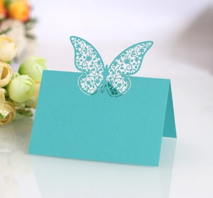 Detail of light blue laser-cut butterfly place cards for wedding table settings