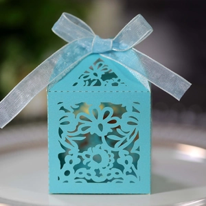 Detail view of light blue laser cut wedding gift box with floral pattern and ribbon