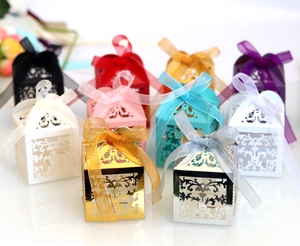 Laser-cut vine pattern wedding favor boxes with satin ribbon bows in multiple colors