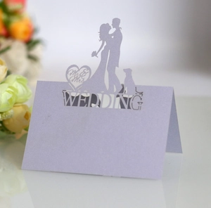Detailed laser-cut lavender wedding seat card featuring a romantic couple silhouette