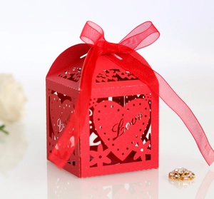 Close-up of red hollowed Love heart candy box with elegant silk ribbon bow detail