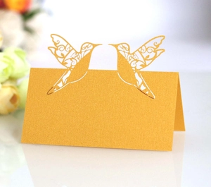 Golden laser-cut lovebird place cards for weddings with elegant pearl paper texture