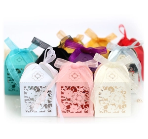 Laser-cut floral favor boxes with organza ribbon bows in various elegant colors