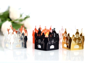 Laser-cut Halloween castle paper candle shades in multiple colors including gold and orange
