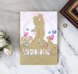 Detail of glitter gold laser-cut wedding topper with couple and dog silhouette