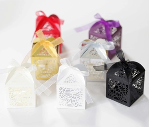 Detail of laser-cut spider web gift boxes with matching ribbon bows for Halloween candy