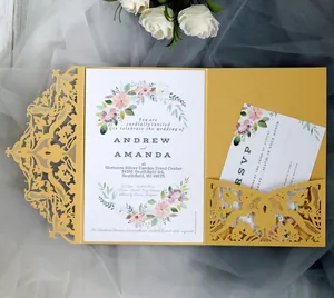 Gold laser-cut lace wedding invitation set with floral card on blue tulle background