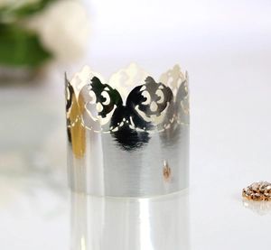 Silver laser-cut crown paper tea light holder with glossy reflective finish for events