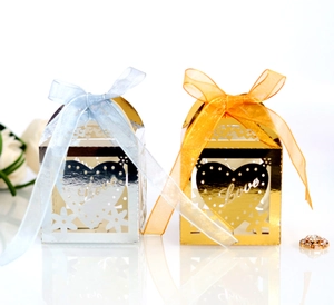 Detailed view of laser-cut heart candy boxes in gold and silver with Love design