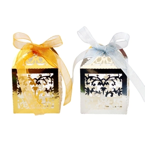 Intricate laser-cut lace wedding candy boxes in gold and silver with elegant silk ribbons