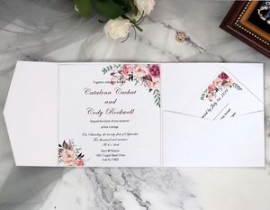 Floral wedding invitation set with pocket sleeve on white marble background