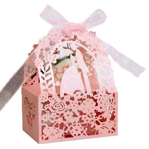 Detail of pink laser-cut wedding candy box with rose patterns and ribbon bow