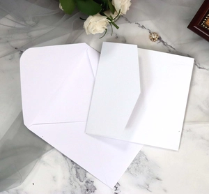 Macro view of white square paper envelopes with smooth texture for wedding invitations