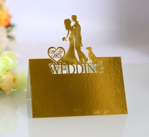 Detailed laser cut heart design on gold wedding table card with Mr and Mrs silhouette