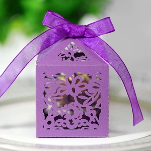 Detailed laser-cut floral pattern on purple gift box with elegant organza ribbon