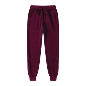 Detail of burgundy fleece jogger pants featuring ribbed cuffs and drawstring waist