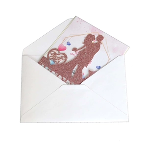 Macro shot of laser cut rose gold glitter wedding card with Love heart silhouette