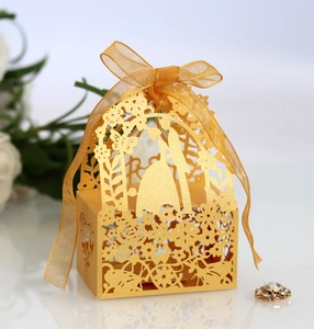 Detailed laser-cut hollow candy box with gold ribbon and romantic wedding silhouettes