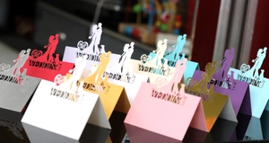 Detailed laser cut butterfly wedding place cards in various pearlescent paper colors
