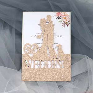 Detail of laser-cut wedding invitation with champagne gold glitter and floral inner card