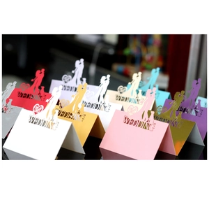 Laser-cut hollow butterfly wedding place cards in various colors with elegant silhouettes