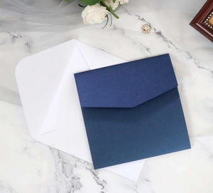 Macro shot of elegant ivory and navy blue pearlescent envelopes for formal invitations