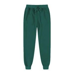 Detail of dark green joggers showing the elastic waistband and ribbed ankle cuffs