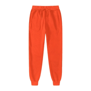 Close-up of orange sports joggers featuring elastic drawstring waist and side pockets