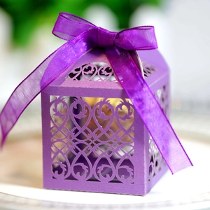 Detailed laser-cut purple gift box with intricate vine patterns and matching satin ribbon