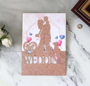 Detail of rose gold glitter laser-cut wedding invitation with bride and groom silhouette