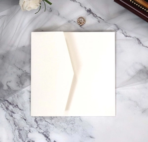 Detailed view of an ivory square invitation envelope with a unique V-shape overlap closure