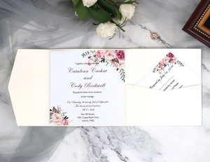 Ivory wedding invitation set with floral watercolor design on marble background