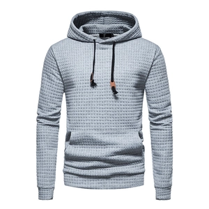 Detail of light grey waffle knit fabric texture on men's long sleeve hoodie