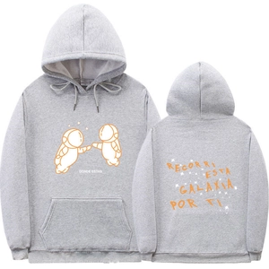 Front and back view of light gray hoodie with orange astronaut graphics and Spanish text