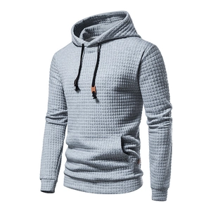 Detail of grey men's hoodie showing waffle knit texture and leather drawcord accents